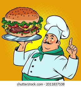 a chef with a large burger on a tray. Fast food and street restaurants