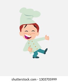 Chef laughing while teaching something to his left.