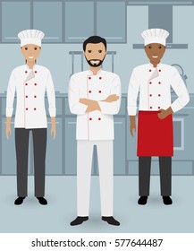 Chef and two cook in uniform standing together in three different poses on a kitchen background. Cooking people characters. Flat vector illustration..
