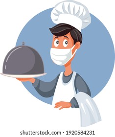 Chef Wearing a Mask Holding a Platter. Restaurant opening during covid-19 pandemic 
