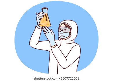 Chemist laboratory assistant holds test tube with reagent examining hazardous substance, dressed in chemical protection clothing. Female chemist examines contents of flask after synthesis