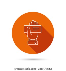 Cheque icon. Giving hand sign. Paying check in palm symbol. Round orange web button with shadow.