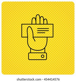 Cheque icon. Giving hand sign. Paying check in palm symbol. Linear icon on orange background. Vector