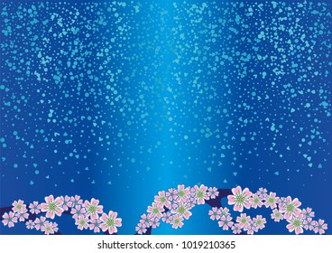 Cherry blossom branch with falling petals on a blue background