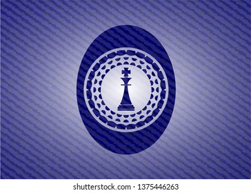 chess king icon inside badge with denim background
