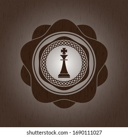 chess king icon inside badge with wood background