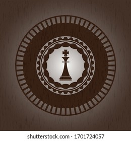 chess king icon inside badge with wooden background