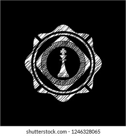 chess king icon inside chalkboard emblem written on a blackboard