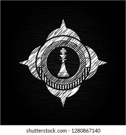 chess king icon inside chalkboard emblem on black board