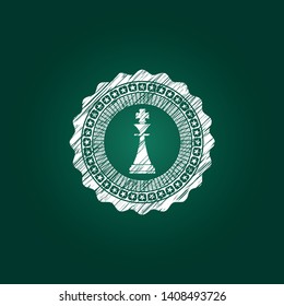 chess king icon inside chalkboard emblem written on a blackboard