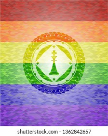 chess king icon inside emblem on mosaic background with the colors of the LGBT flag