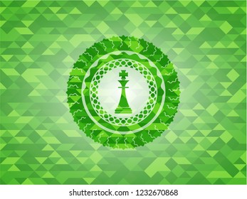 chess king icon inside green emblem. Mosaic background