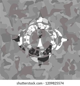 chess king icon inside grey camouflage emblem