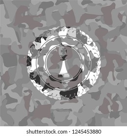 chess king icon inside grey camo emblem