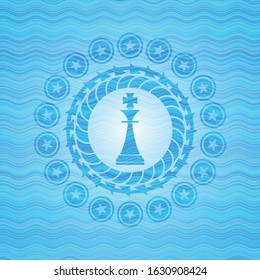 Chess King Icon Inside Light Blue Water Wave Badge.