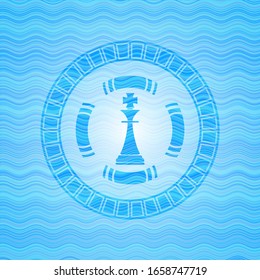 Chess King Icon Inside Light Blue Water Wave Badge.