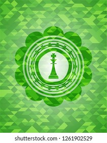 chess king icon inside realistic green mosaic emblem