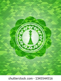 chess king icon inside realistic green mosaic emblem