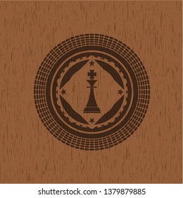 chess king icon inside realistic wood emblem