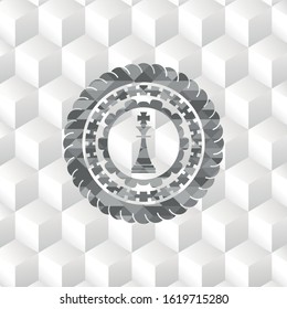 chess king icon inside realistic grey emblem with geometric cube white background