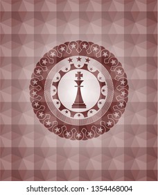chess king icon inside red seamless geometric badge.