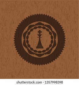 chess king icon inside retro wooden emblem