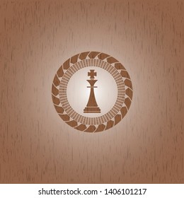 chess king icon inside retro wooden emblem