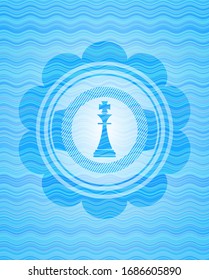 chess king icon inside water wave concept style badge.