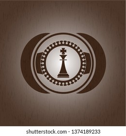 chess king icon inside wood badge or emblem