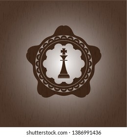 chess king icon inside wood badge or emblem