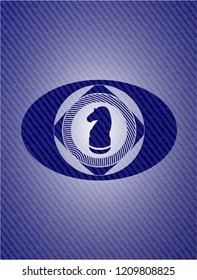 chess knight icon inside badge with denim background