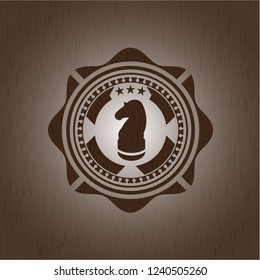 chess knight icon inside badge with wooden background