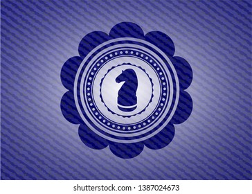 chess knight icon inside badge with denim texture