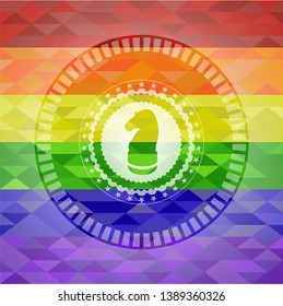 chess knight icon inside emblem on mosaic background with the colors of the LGBT flag