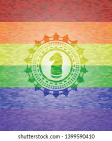 chess knight icon inside emblem on mosaic background with the colors of the LGBT flag