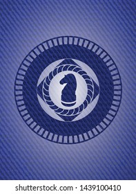chess knight icon inside emblem with denim texture