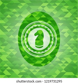chess knight icon inside green mosaic emblem
