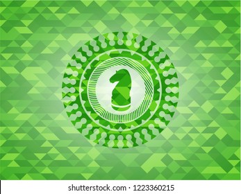 chess knight icon inside green mosaic emblem