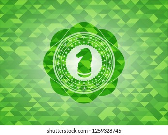 chess knight icon inside green emblem with mosaic background