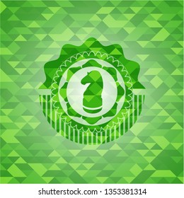 chess knight icon inside green mosaic emblem