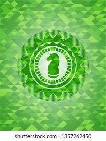 chess knight icon inside green emblem with mosaic ecological style background