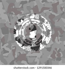 chess knight icon inside grey camo emblem
