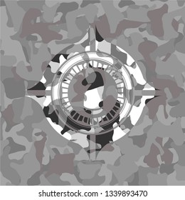 chess knight icon inside grey camouflage texture