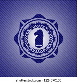 chess knight icon inside jean or denim emblem or badge background