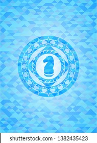 chess knight icon inside light blue mosaic emblem