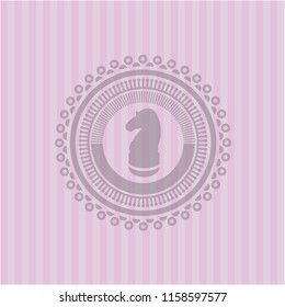 chess knight icon inside pink emblem