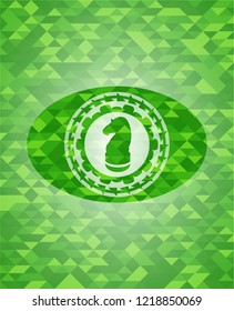 chess knight icon inside realistic green emblem. Mosaic background