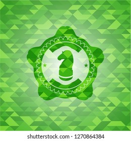 chess knight icon inside realistic green mosaic emblem
