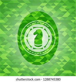 chess knight icon inside realistic green emblem. Mosaic background