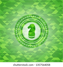 chess knight icon inside realistic green emblem. Mosaic background
